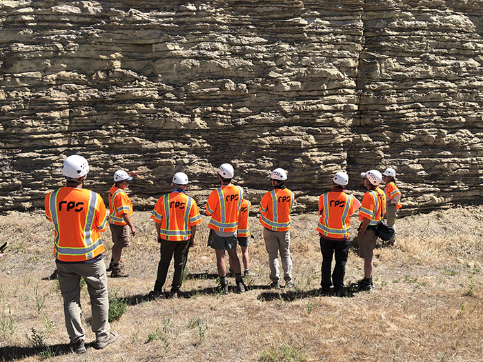 Participants out in the field wearing safety equipment