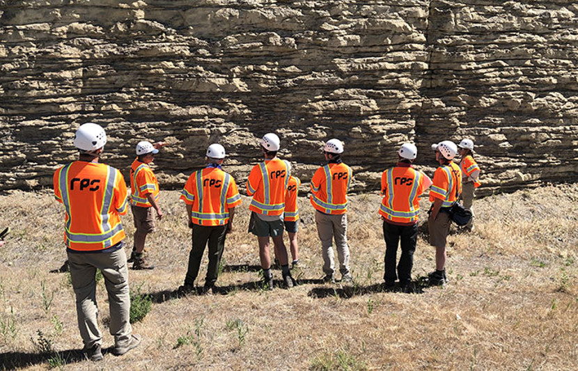 Participants out in the field wearing safety equipment